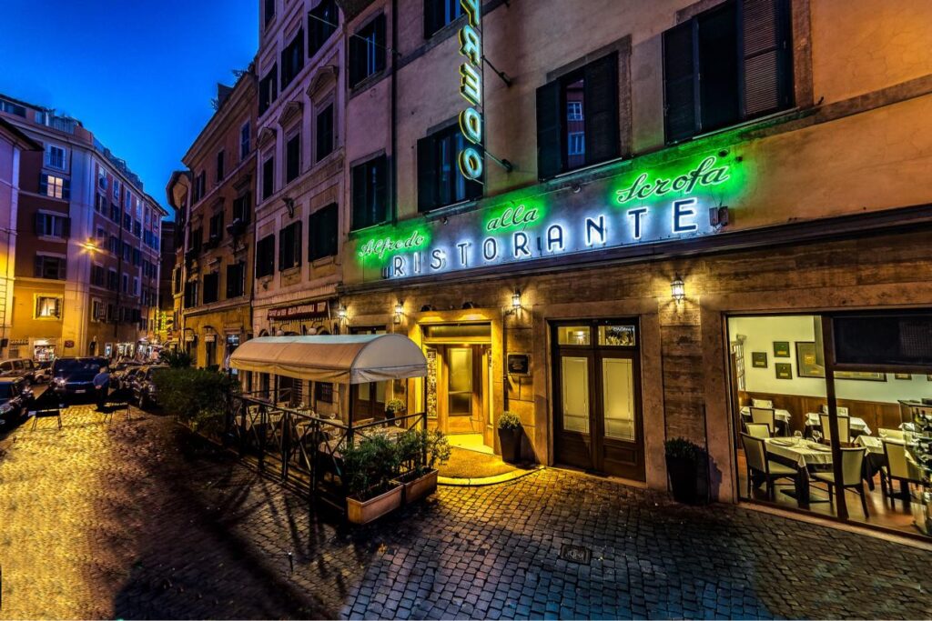 Historic exterior of Alfredo alla Scrofa restaurant in Rome, birthplace of the original Alfredo sauce recipe.
